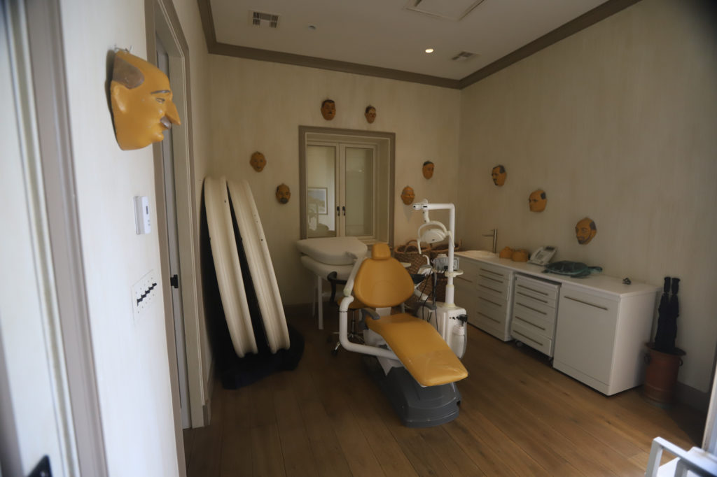 A fully equipped dental office on Little St. James, with face masks hung on the walls.